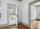 Entryway featuring hardwood floors, neutral paint, and a view of the front yard through a screen door at 1628 Park Dr, Raleigh, NC 27605