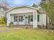 Single-story home featuring a covered porch, green shutters, and a meticulously maintained lawn at 1628 Park Dr, Raleigh, NC 27605
