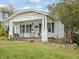 Charming single-story home featuring a cozy front porch, green shutters, and well-maintained landscaping at 1628 Park Dr, Raleigh, NC 27605