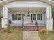 View of the porch area featuring black railings, a gray floor, and classic white columns at 1628 Park Dr, Raleigh, NC 27605