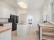Bright kitchen with white cabinets, butcher block countertops, an island, and a black refrigerator at 1628 Park Dr, Raleigh, NC 27605