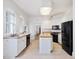 Bright kitchen with white cabinets, butcher block island, and black appliances at 1628 Park Dr, Raleigh, NC 27605