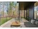 Inviting back porch with modern furniture and wooded view provides a relaxing outdoor living space at 168 Daphine Dr, Hillsborough, NC 27278