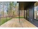 Expansive back porch featuring wood flooring, sleek railing and sliding glass doors at 168 Daphine Dr, Hillsborough, NC 27278