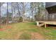 Spacious backyard featuring a well-maintained lawn and access steps to the patio at 168 Daphine Dr, Hillsborough, NC 27278