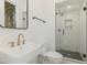 Bright bathroom features a glass shower, white tiled walls, and modern fixtures at 168 Daphine Dr, Hillsborough, NC 27278