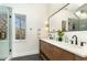 Stylish bathroom boasts dual vanities, modern fixtures, and a shower with natural light at 168 Daphine Dr, Hillsborough, NC 27278