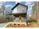 A modern two-story home with a welcoming porch, a metal roof, and a contemporary design at 168 Daphine Dr, Hillsborough, NC 27278