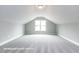 Carpeted bonus room features a large window and neutral paint at 169 Tigris Ct, Zebulon, NC 27597