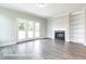 Living room with a cozy fireplace, built-in shelves, and sliding glass doors at 169 Tigris Ct, Zebulon, NC 27597