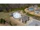 Aerial view featuring the community pool and clubhouse with nearby homes at 1715 Capstone Dr, Durham, NC 27713