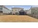 Large, grassy backyard featuring a screened-in porch and lush landscaping at 1715 Capstone Dr, Durham, NC 27713