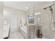 Bright bathroom showcasing a glass-enclosed shower and a soaking tub with a view at 1715 Capstone Dr, Durham, NC 27713