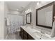 Bathroom features a double vanity, marble countertop, and a shower at 1715 Capstone Dr, Durham, NC 27713