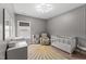 Well-lit Bedroom features a crib, chair, and changing table at 1715 Capstone Dr, Durham, NC 27713