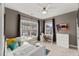 Neutral bedroom featuring a bed, desk, and two large windows at 1715 Capstone Dr, Durham, NC 27713