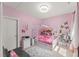 Pink bedroom with a decorative bed frame and cute butterfly wall art at 1715 Capstone Dr, Durham, NC 27713
