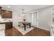 Elegant dining area with modern lighting, hardwood floors, and access to the outdoors at 1715 Capstone Dr, Durham, NC 27713