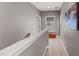 Neutral hallway with a decorative map on the wall and a window nook with seating at 1715 Capstone Dr, Durham, NC 27713