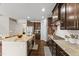 Open-concept kitchen with a large island, stainless appliances, and wood flooring at 1715 Capstone Dr, Durham, NC 27713