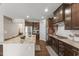 Modern kitchen with dark wood cabinets, stainless appliances, and granite countertops at 1715 Capstone Dr, Durham, NC 27713