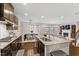 Open kitchen featuring island with seating, stainless steel appliances, and modern design at 1715 Capstone Dr, Durham, NC 27713