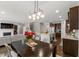 Open concept living space with modern lighting, a fireplace, and a dining area at 1715 Capstone Dr, Durham, NC 27713