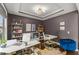 Well-lit home office with multiple work spaces, modern lighting, and decor at 1715 Capstone Dr, Durham, NC 27713