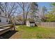 Large backyard with shade trees, shed, play area and deck at 202 High St, Carrboro, NC 27510