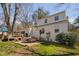 Backyard patio and outdoor dining area with shade trees and grill at 202 High St, Carrboro, NC 27510
