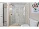 Bathroom featuring a glass enclosed shower with gold hardware and neutral colored tile at 202 High St, Carrboro, NC 27510