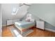 Bright bedroom with hardwood floors, a skylight, a ceiling fan, and neutral paint at 202 High St, Carrboro, NC 27510