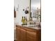 Close-up shot of a wooden cabinet with wine bottles, glasses, and a decorative mirror at 202 High St, Carrboro, NC 27510