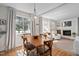 Bright dining area with hardwood floors, a wood table, a modern light fixture, and plenty of natural light at 202 High St, Carrboro, NC 27510