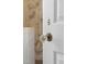 Close-up of a vintage-style crystal doorknob on a white paneled door, adding a touch of elegance at 202 High St, Carrboro, NC 27510
