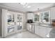 Bright kitchen features white cabinets, granite countertops, stainless appliances, and access to the backyard at 202 High St, Carrboro, NC 27510