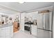 Modern kitchen with stainless steel appliances, white cabinets, and a view into the adjacent dining area at 202 High St, Carrboro, NC 27510