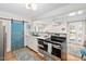 Bright and airy kitchen with stainless steel appliances, and decorative sliding door to bedroom at 202 High St, Carrboro, NC 27510