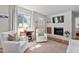 Comfortable living room with white armchairs, fireplace, and hardwood floors with decorative rug at 202 High St, Carrboro, NC 27510