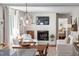 Open-concept living room with fireplace, hardwood floors and view into the dining area at 202 High St, Carrboro, NC 27510