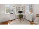 Bright home office space with modern desk, neutral walls, and ample natural light from the windows at 202 High St, Carrboro, NC 27510