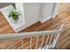Bright staircase showcasing hardwood floors, white trim, and a painted brick detail with decorative flowers at 202 High St, Carrboro, NC 27510