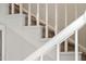 Staircase with white railings, carpeted steps, and freshly painted white risers at 202 High St, Carrboro, NC 27510