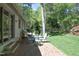 Backyard patio with outdoor seating and a stainless steel grill overlooking a lush, wooded lot at 21 Wedgewood Rd, Chapel Hill, NC 27514