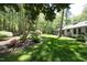 The backyard is lush with mature trees, green grass, and tasteful landscaping at 21 Wedgewood Rd, Chapel Hill, NC 27514