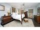 Elegant primary bedroom with a four-poster bed, decorative rug, and ample natural light at 21 Wedgewood Rd, Chapel Hill, NC 27514