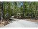 Long gravel driveway leading to a home surrounded by dense trees and natural beauty at 21 Wedgewood Rd, Chapel Hill, NC 27514