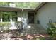 Elegant home entrance featuring brick steps, manicured landscaping, and a stylish front door at 21 Wedgewood Rd, Chapel Hill, NC 27514