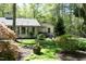 The exterior of the home offers mature landscaping, a fenced in yard and a cozy covered porch at 21 Wedgewood Rd, Chapel Hill, NC 27514