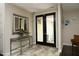 Stylish foyer with tiled floors, decorative mirror, and a view into the outdoor space at 21 Wedgewood Rd, Chapel Hill, NC 27514